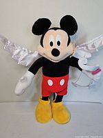 Full view of 24" Mickey Mouse cupid plush with wings, bow and arrow