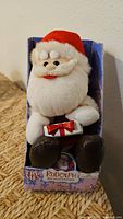 Front view of boxed Gemmy animated Santa plush