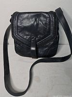 Full view of Harley Davidson black leather crossbody purse showing strap and flap