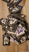 Pile of sealed ApronHeroes apron packages on floor