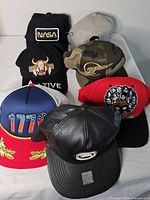 Group shot of all seven assorted caps