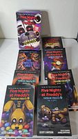 All eight Five Nights at Freddy's books displayed