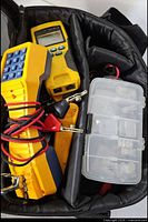 Bag view showing butt set, cable tester, connector box and leads