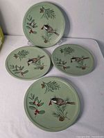 Front view of four matching Winterwood plates