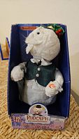 Front view of boxed Sam the Snowman plush showing figure and packaging