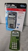 Sealed TI-30Xa and loose green TI-30XIIS