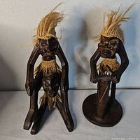 Both tiki figurines side by side showing size and design