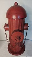Full view of red tin fire hydrant with removable top