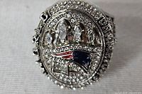 Front view showing Patriots logo, Lombardi trophies and rhinestones