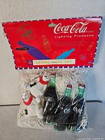 Front view packaged Coca-Cola string light set showing polar bear and bottle covers