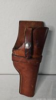 Front view of brown leather George Lawrence holster showing snap strap and stitching