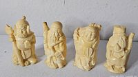 Four resin figurines front view
