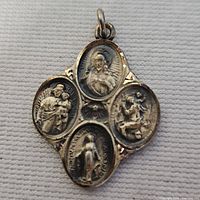 Front view of sterling four-way medal showing saint images