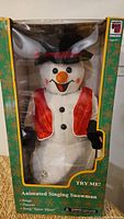 Front view of boxed animated singing snowman showing full figure and packaging