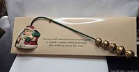 Full view of Santa candle snuffer on display card