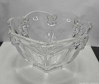 Front view showing scalloped rim and butterfly reliefs