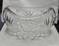 side view showing oval shape, starburst cuts, scalloped rim