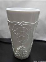 Front view showing grapevine relief on milk glass cup