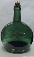 front view of green glass bottle with cork