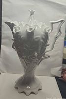 Full view of white porcelain urn with lid in place