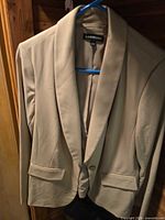 Front view of beige Lane Bryant blazer on hanger