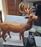Full side view of leather reindeer showing body, legs, antlers