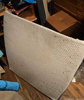 Front view of quilted surface with wear and debris