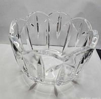 Angled view of clear crystal bowl showing scalloped rim and cut pattern