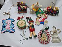Front view of all ten ornaments and keychain displayed