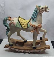 Right side view of resin rocking horse figurine showing pastel accents