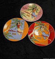 Front view of three Tahitian Moon Bar plates in pink, orange, red