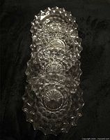 Four stacked clear crystal salad plates showing overall pattern