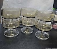 Front view of six smoked amber coupe glasses