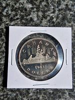 Reverse of 1983 Canada Voyageur Canoe nickel dollar in 2x2 flip