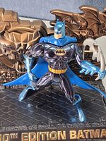 Front view of Batman figurine on 100th Edition base holding batarang