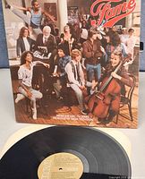 Front cover of gatefold jacket with cast and partial view of record