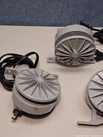 Front views of three identical LED fixtures with cords