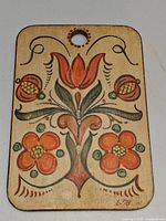 Front of board showing folk art floral painting and signature