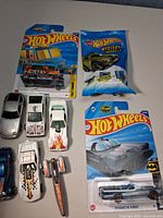 Overview showing carded Quick Bite truck, Mystery Models bag, Batman Batmobile, and several loose cars