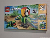 Front of sealed LEGO Creator 31031 box showing main parrot and frog build images