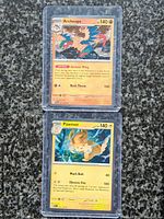 Archeops and Pawmot cards in rigid top loaders