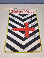 Full view of flag on stick showing design, autographs, finial