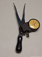 Front view of gauge showing dial, jaws and handle