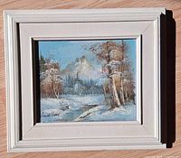 Front view of framed oil painting showing landscape and signature
