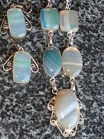 Necklace pendant section and earrings showing banded agate stones and silver settings