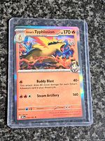 Front view of Ethan's Typhlosion card in top-loader showing artwork, stats and holo foil finish