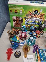 Front of box with grouped figures, portal and crystals visible