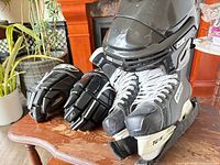 Group view of skates, gloves and helmet on table