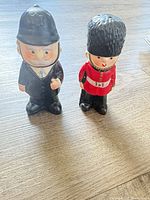 Full view of both novelty shakers standing upright