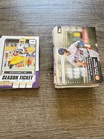Two stacks of trading cards, left stack football Panini Contenders, right stack baseball Topps